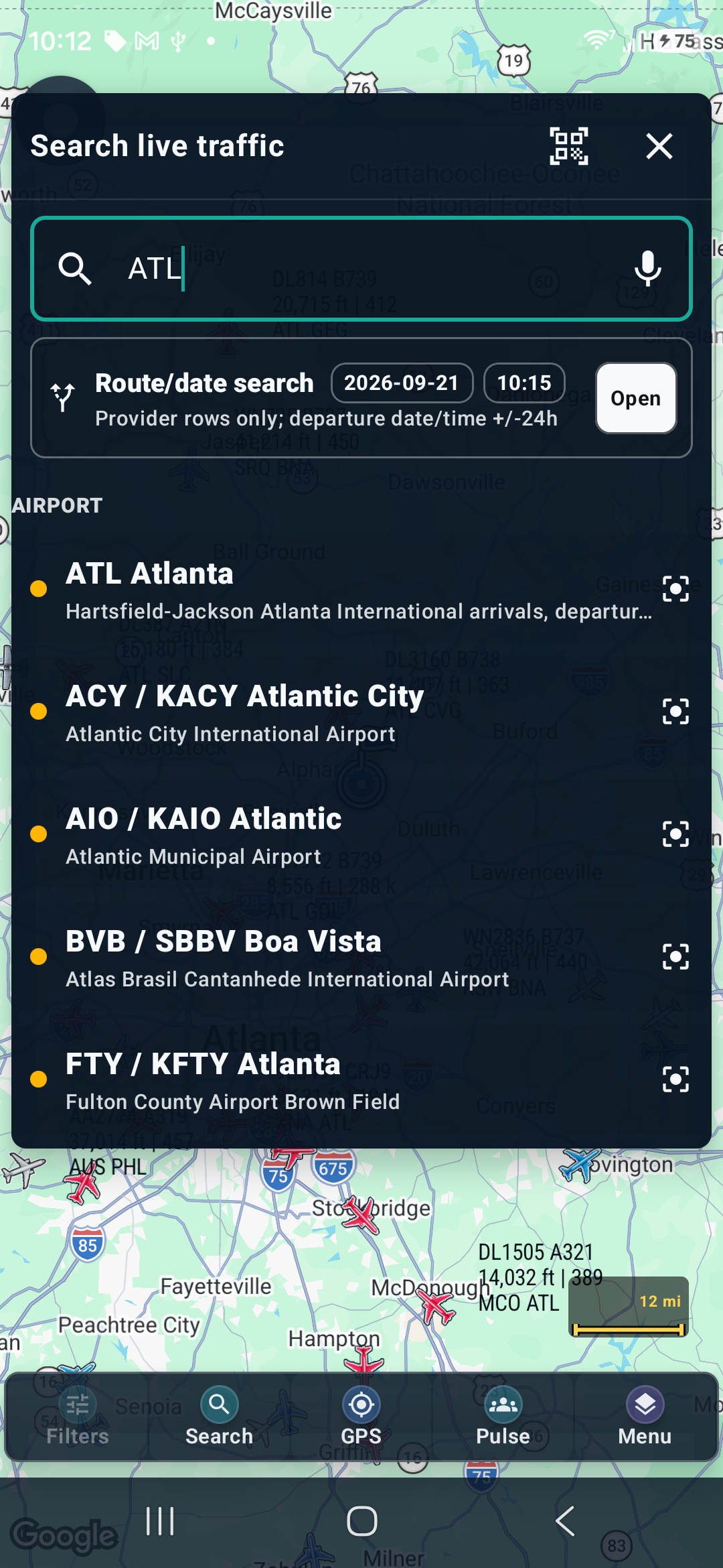 Searching ATL returns matching airports; voice and camera-search controls are above the results